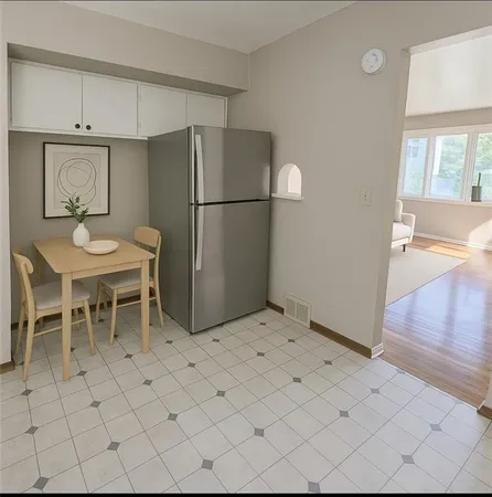a kitchen with a refrigerator and more cabinets