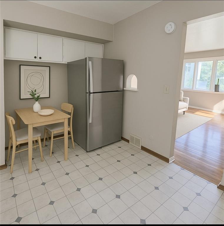 223 Emerson Avenue Farrell, PA 16121 - Photo 14 of 25 a kitchen with a refrigerator and more cabinets