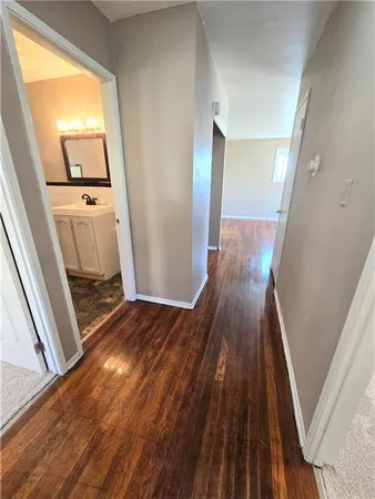 a view of a hallway view with wooden floor and staircase