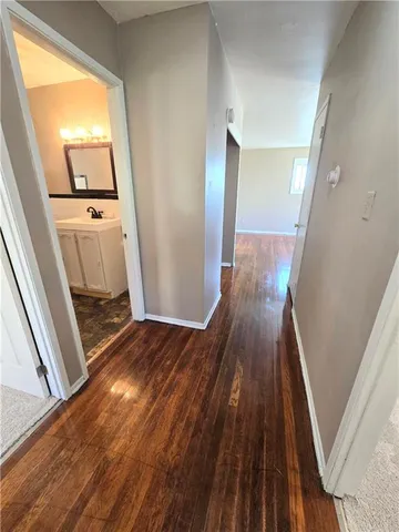 a view of a hallway view with wooden floor and staircase