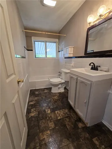 a bathroom with a sink toilet and mirror