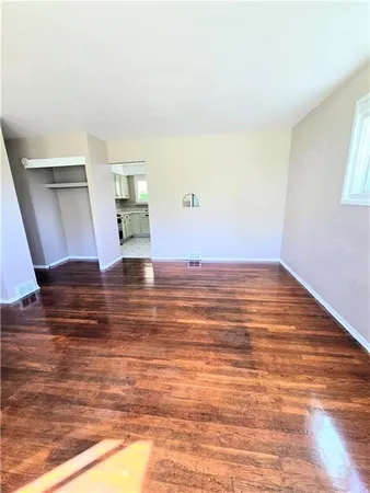 a view of room with wooden floor