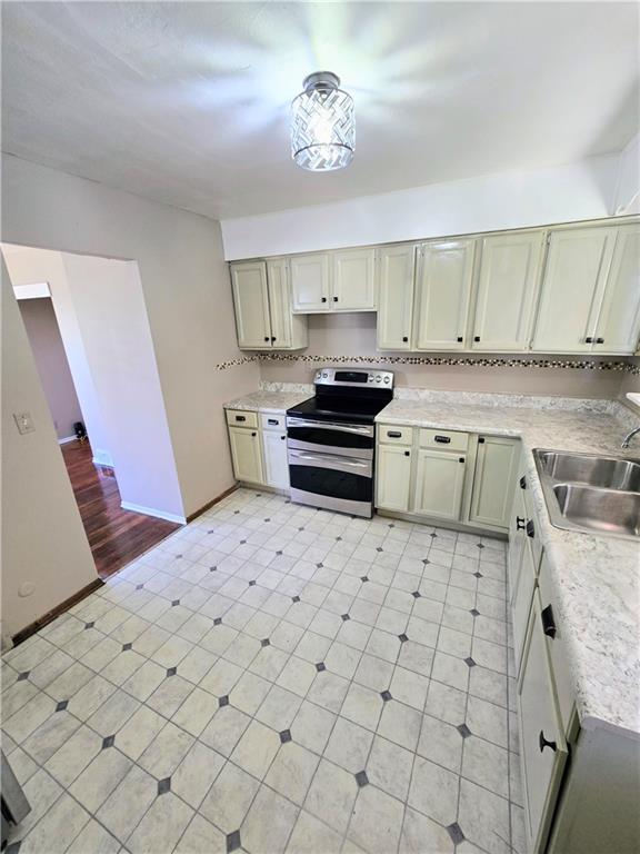 223 Emerson Avenue Farrell, PA 16121 - Photo 10 of 25 a kitchen with stainless steel appliances a stove a sink and a refrigerator