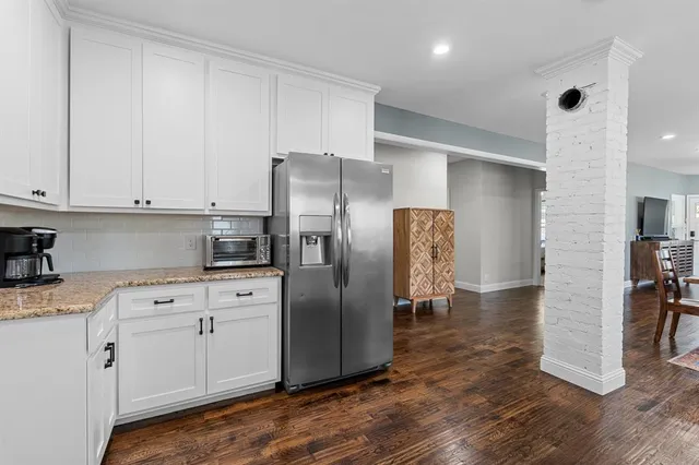 a kitchen with stainless steel appliances a refrigerator sink and cabinets