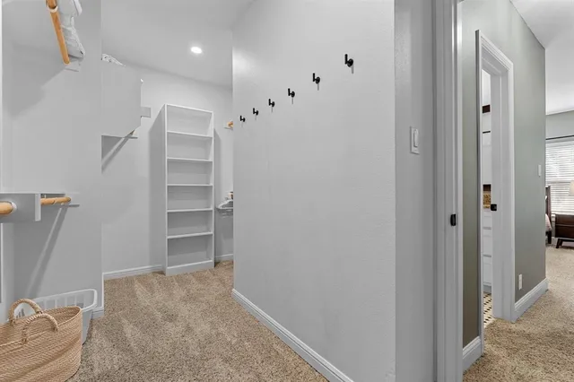 a view of walk in closet with empty racks