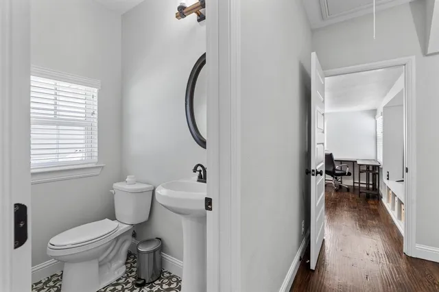 a bathroom with a toilet sink and a mirror