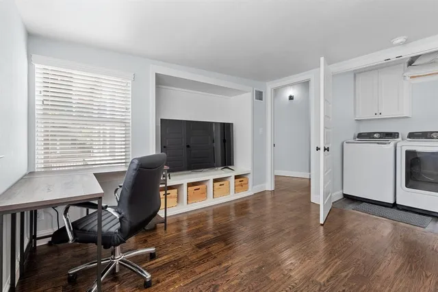 a view of a livingroom with furniture and a flat screen tv