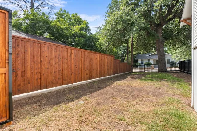 a backyard of a house with trees and outdoor space