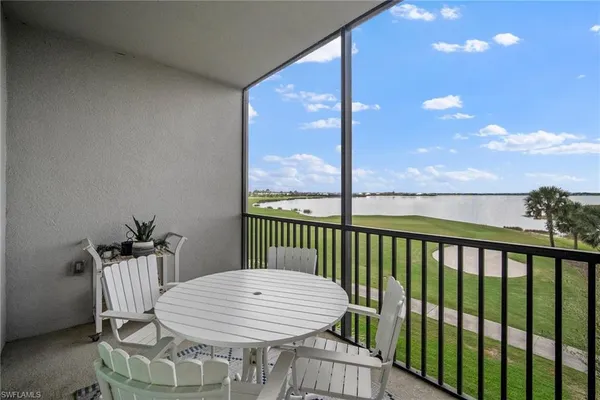 a view of a balcony with chair and wooden floor
