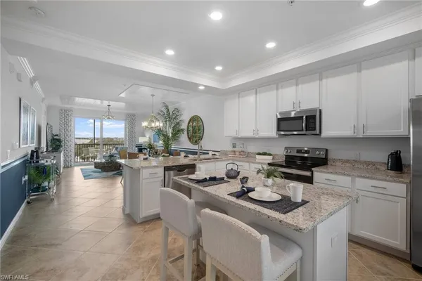 a kitchen with a sink stove cabinets and counter space