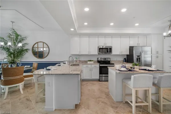 a kitchen with granite countertop a sink stainless steel appliances and cabinets