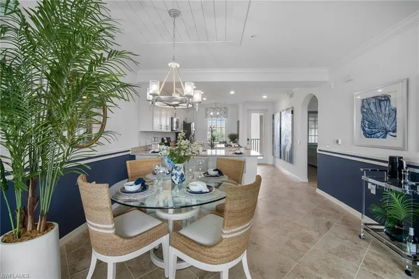 a view of a dining room with furniture and chandelier