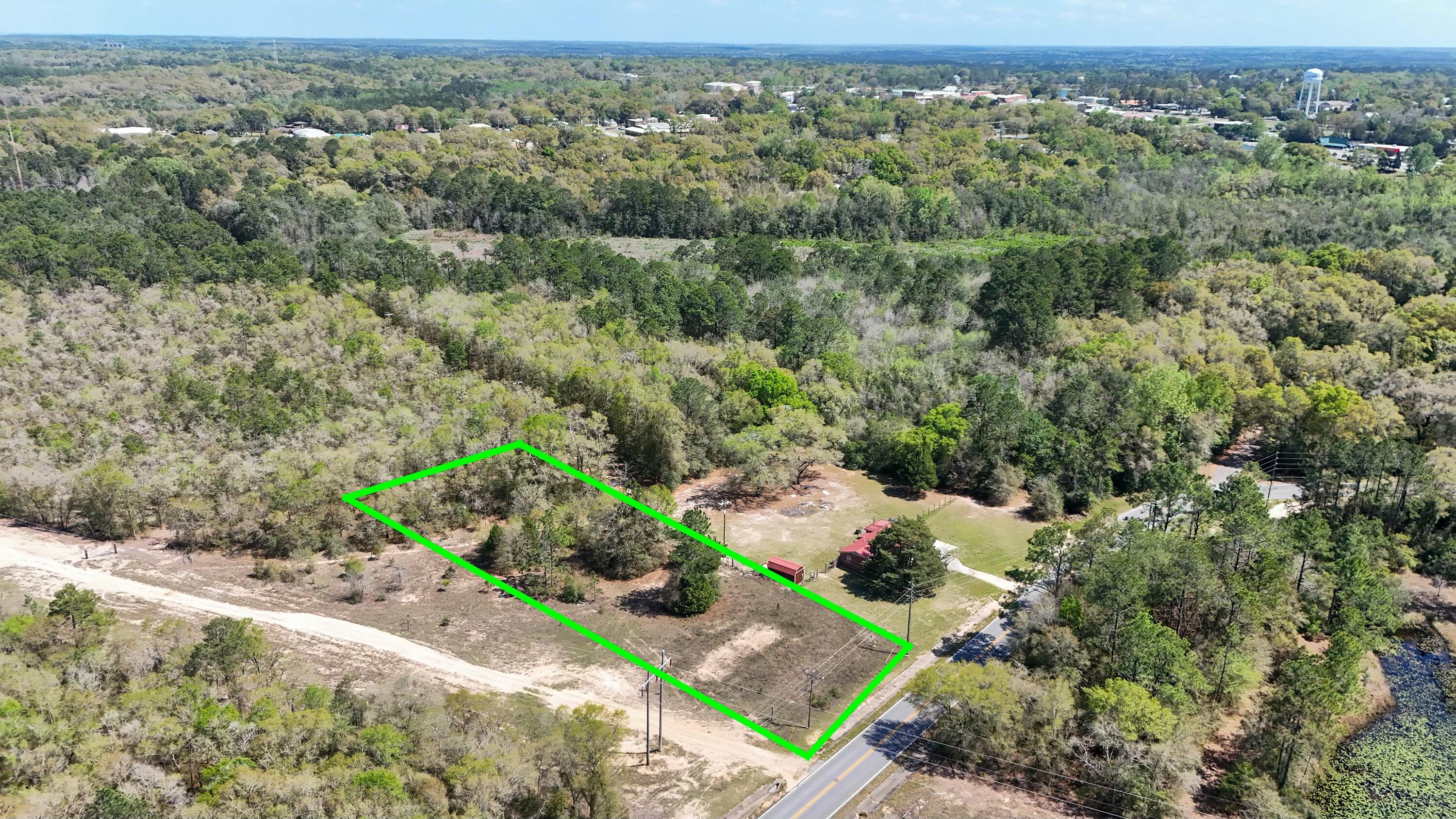 0 North 20th Street DeFuniak Springs, FL 32433 - Photo 6 of 11 an aerial view of a houses with a yard and lake view