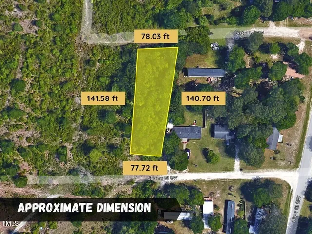 a green field with trees in the background