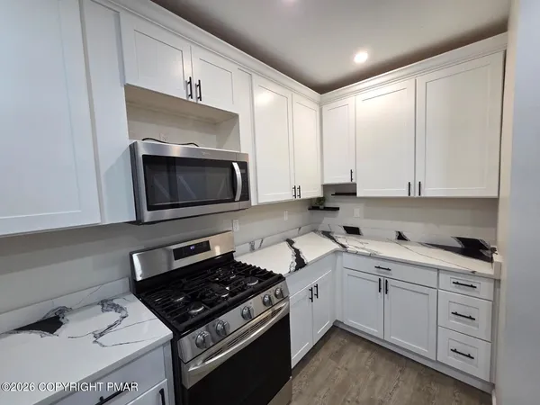 a kitchen with a stove and a microwave