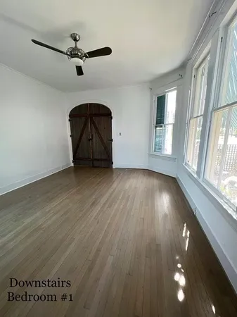 wooden floor in an empty room with a window