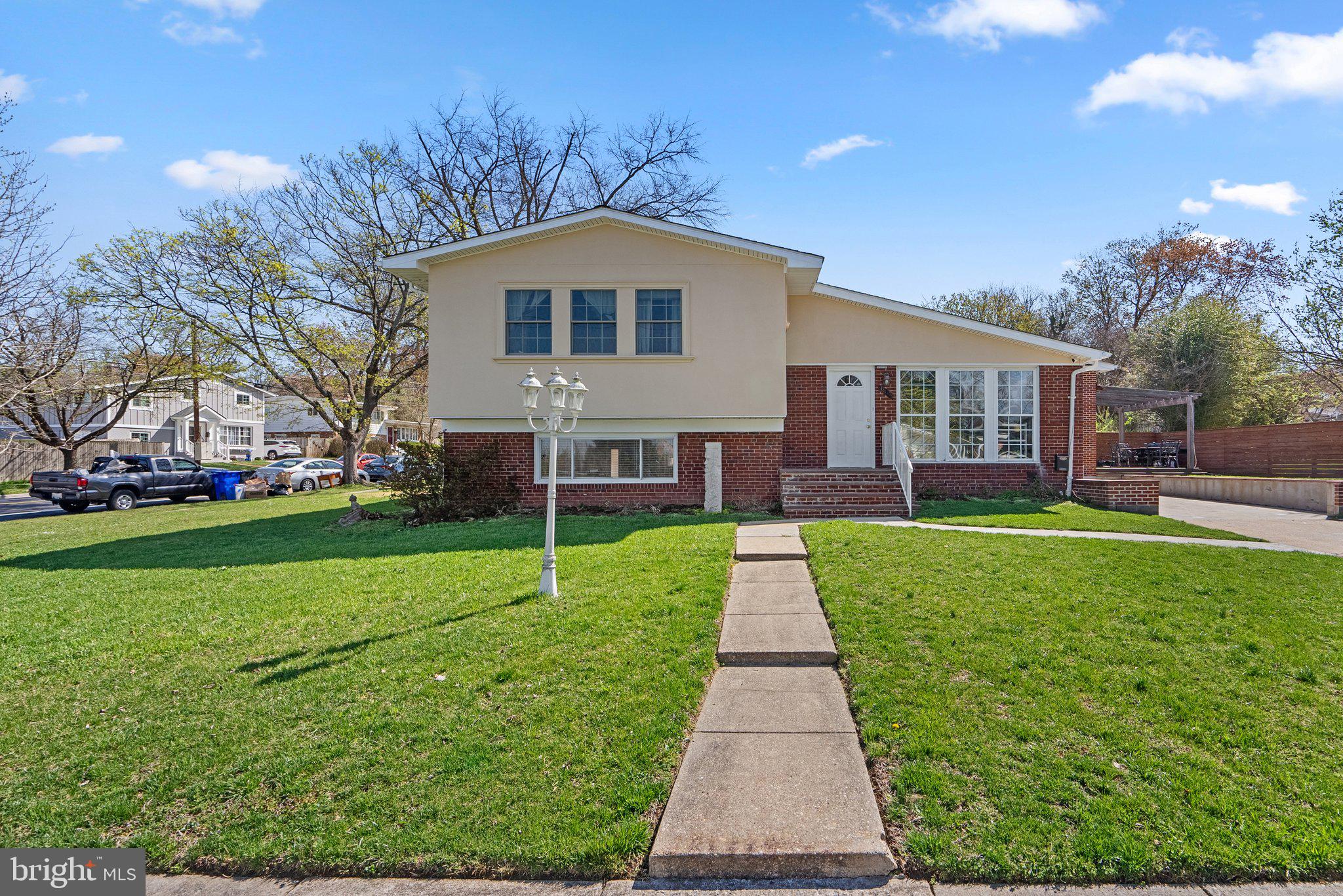 13131 Holdridge Road Silver Spring, MD 20906 - Photo 1 of 41 a front view of a house with a yard table and chairs