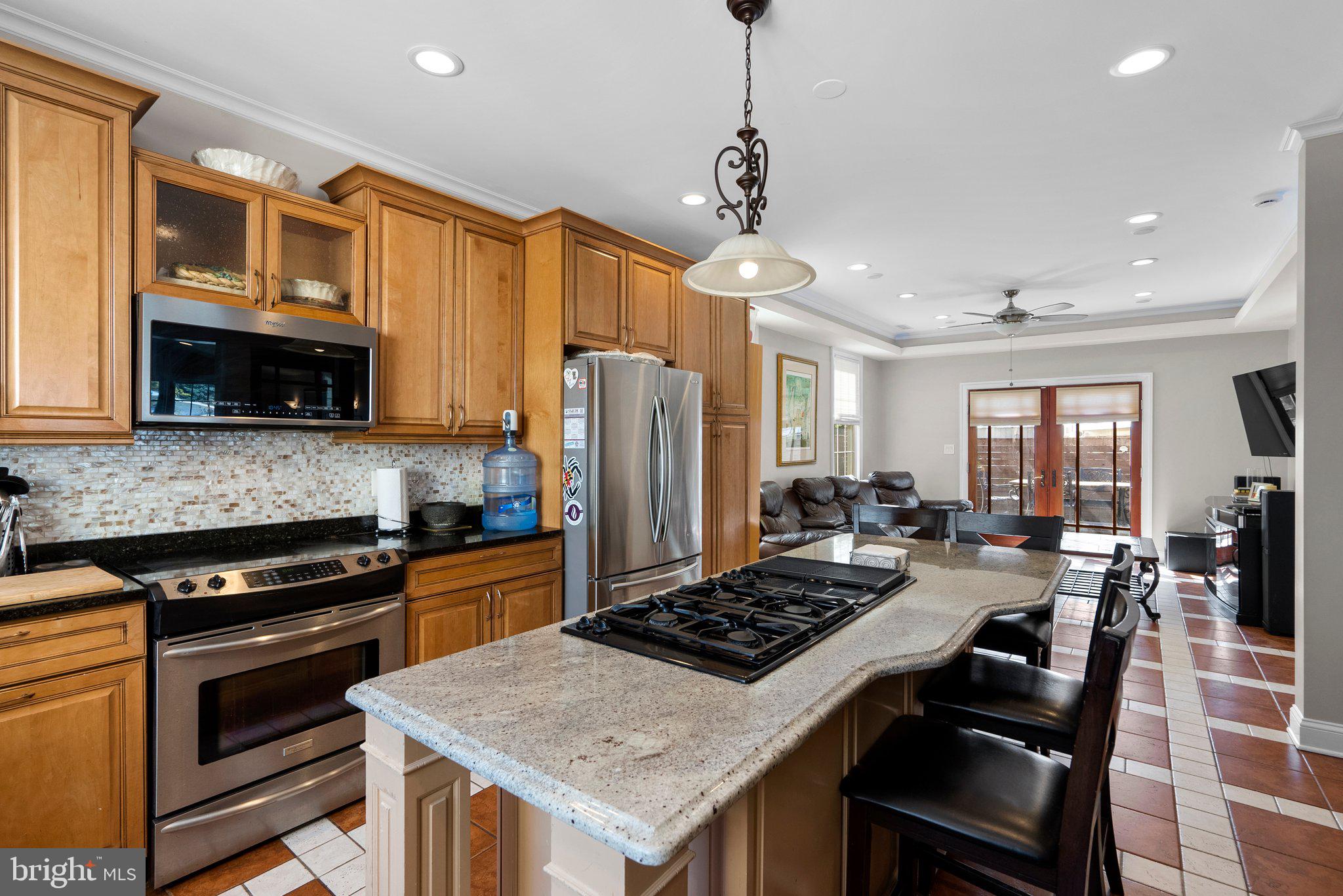 13131 Holdridge Road Silver Spring, MD 20906 - Photo 12 of 41 a kitchen with a stove a sink and a refrigerator
