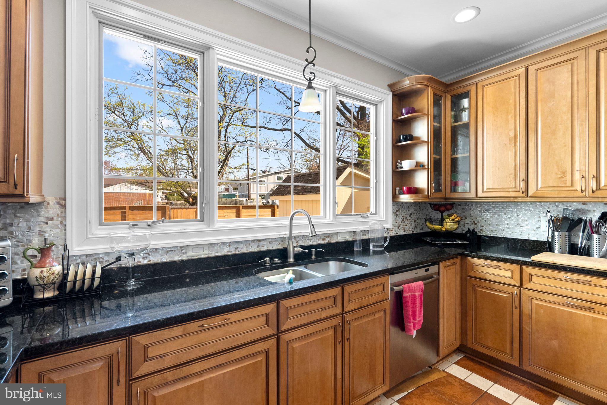 13131 Holdridge Road Silver Spring, MD 20906 - Photo 13 of 41 a kitchen with granite countertop a sink stainless steel appliances window and cabinets