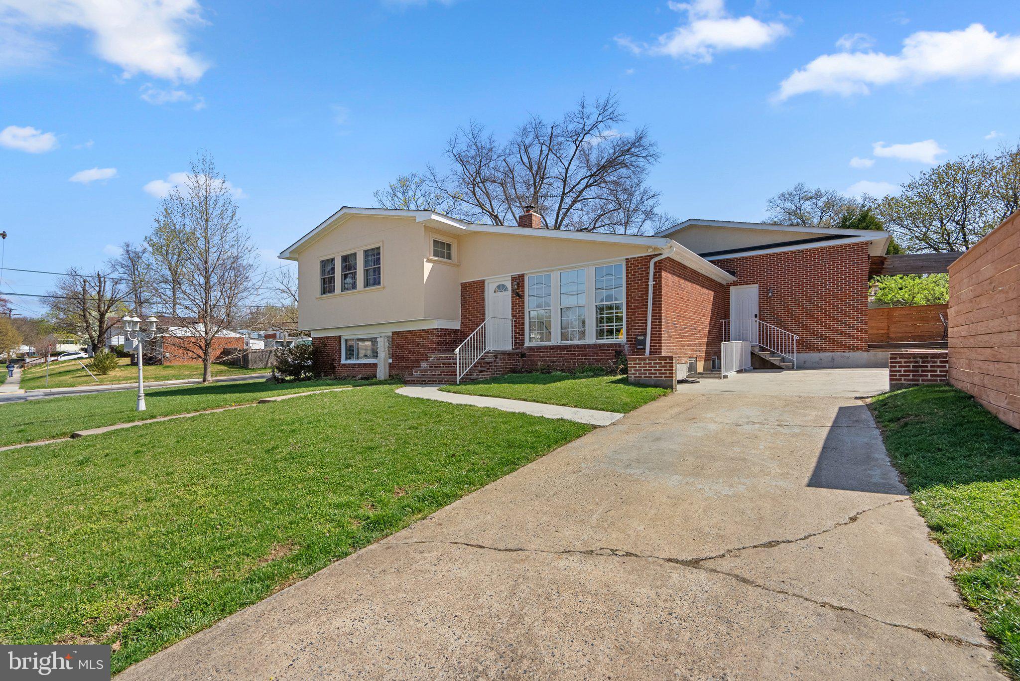 13131 Holdridge Road Silver Spring, MD 20906 - Photo 2 of 41 a front view of a house with a garden and yard