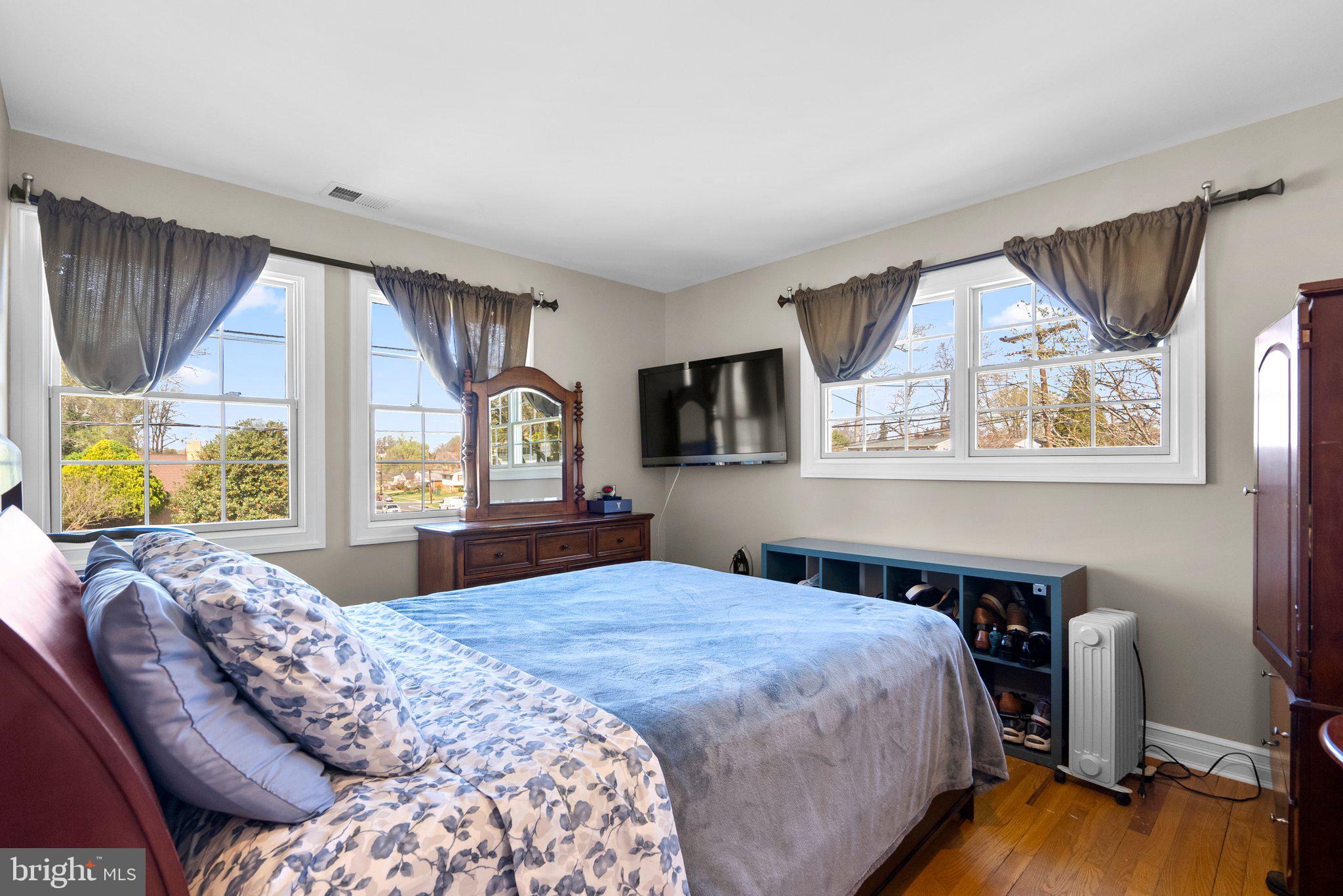13131 Holdridge Road Silver Spring, MD 20906 - Photo 21 of 41 a bedroom with a bed and wooden floor