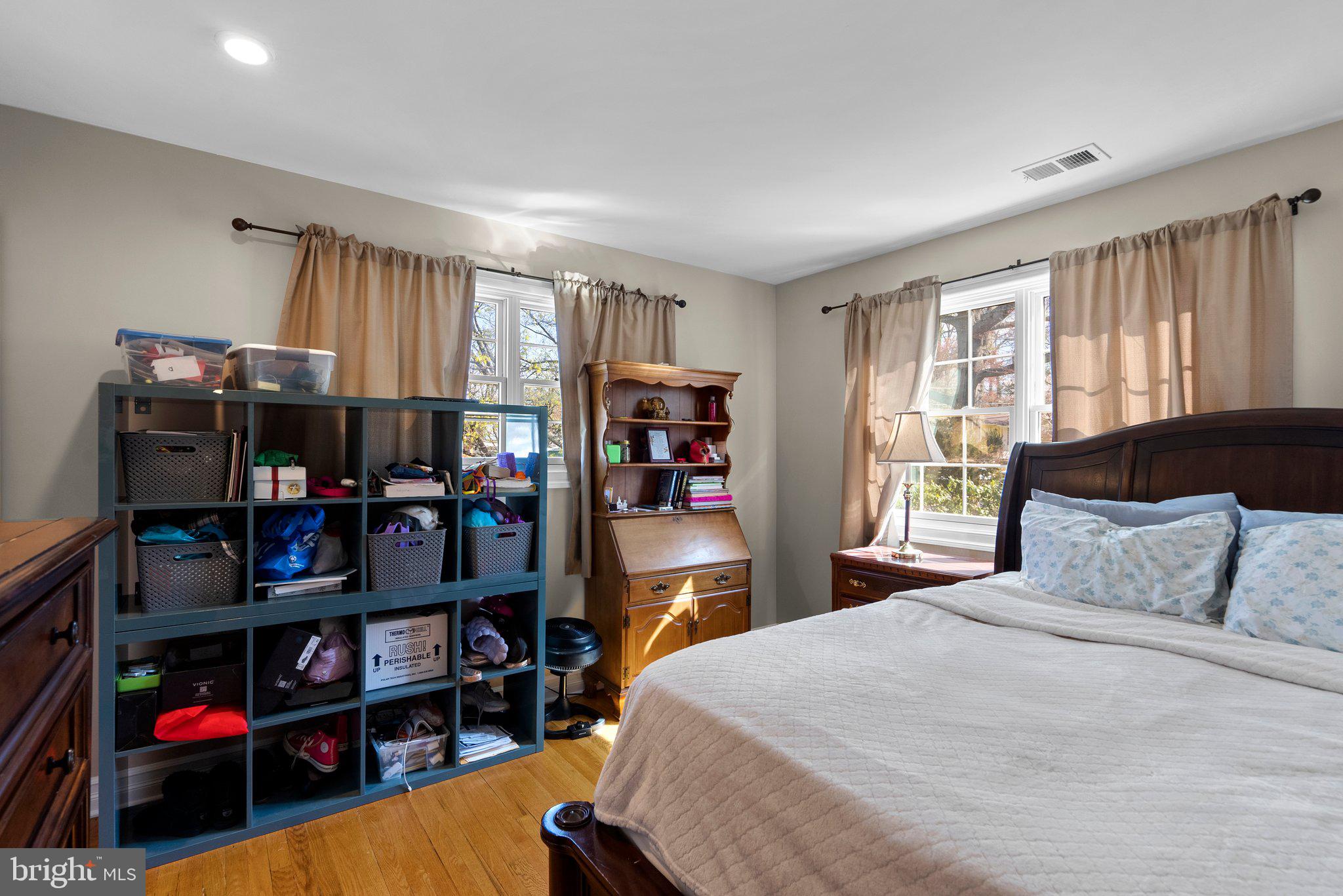 13131 Holdridge Road Silver Spring, MD 20906 - Photo 25 of 41 a bedroom with a bed a large window and book shelf