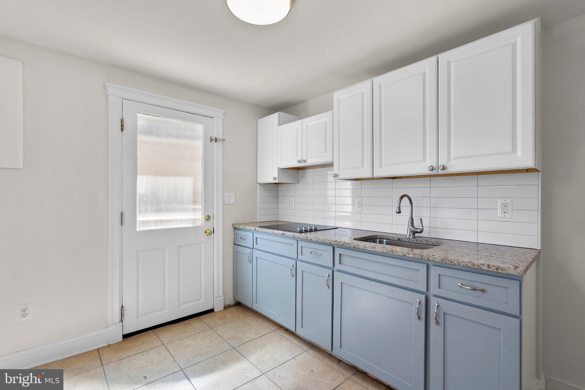 13131 Holdridge Road Silver Spring, MD 20906 - Photo 30 of 41 a kitchen with stainless steel appliances granite countertop a sink and dishwasher with white cabinets