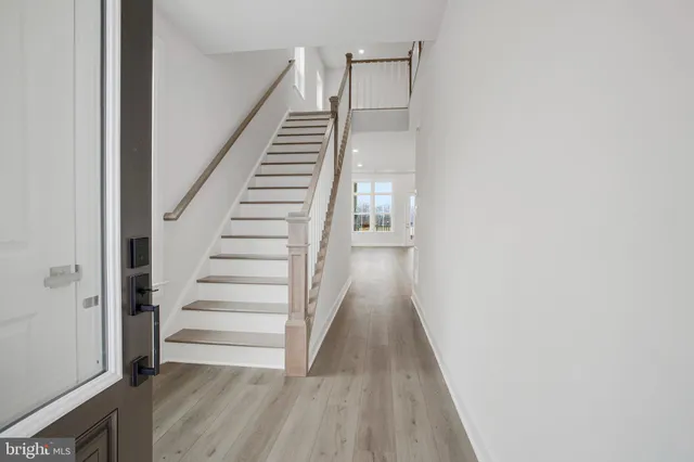 a view of entryway and hall with wooden floor