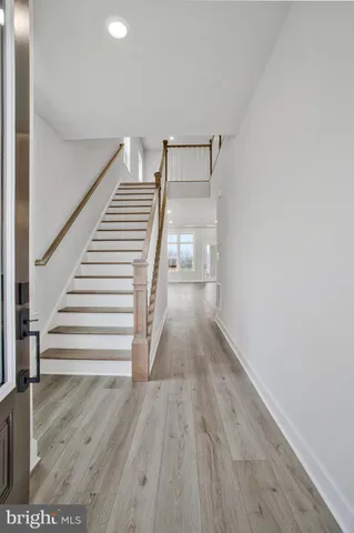 a kitchen with center island wooden floor and a sink
