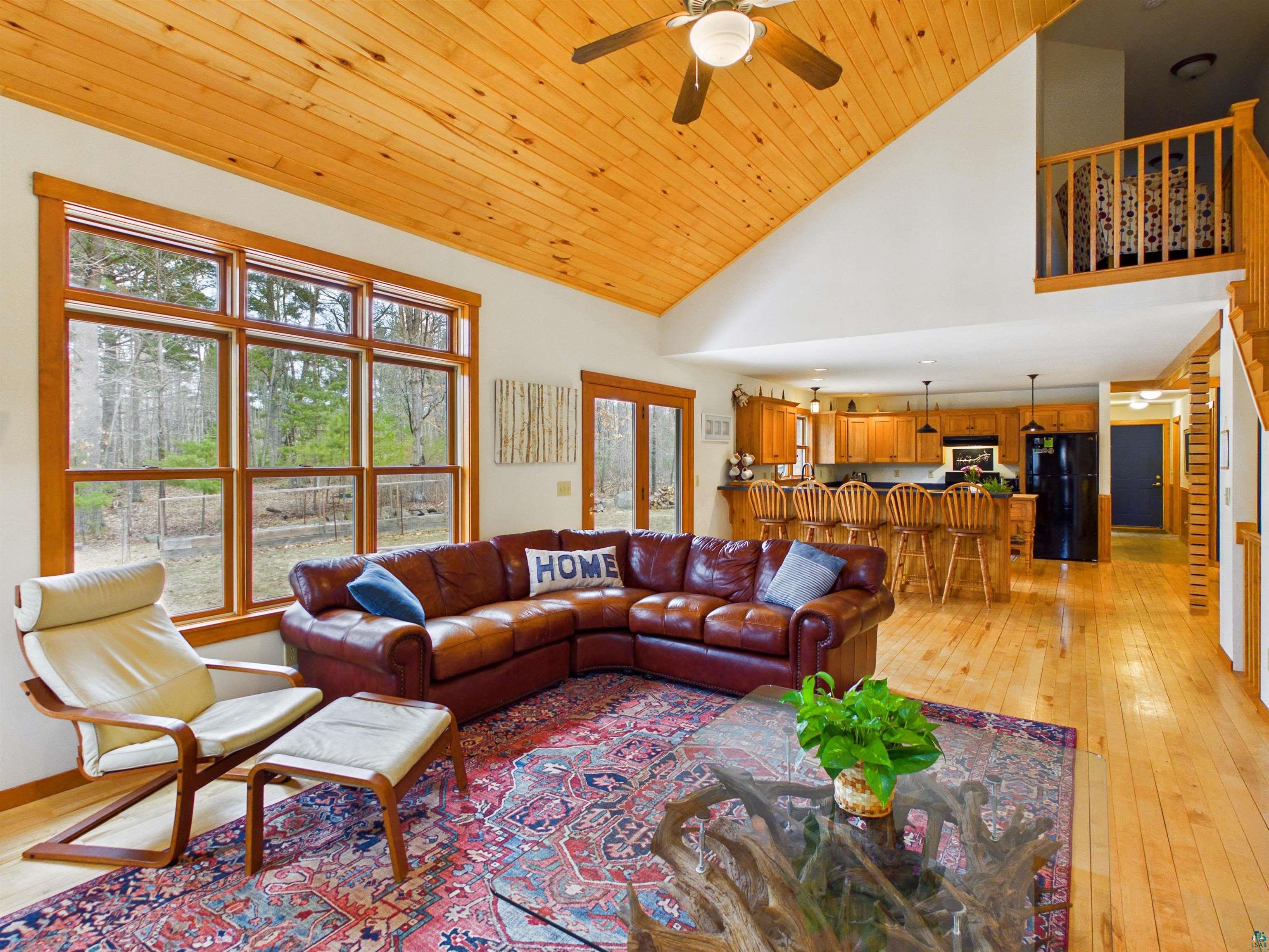 16539 Acorn Ridge Hayward, WI 54843 - Photo 17 of 58 Living room featuring ceiling fan, light wood-style floors, and a vaulted wood ceiling