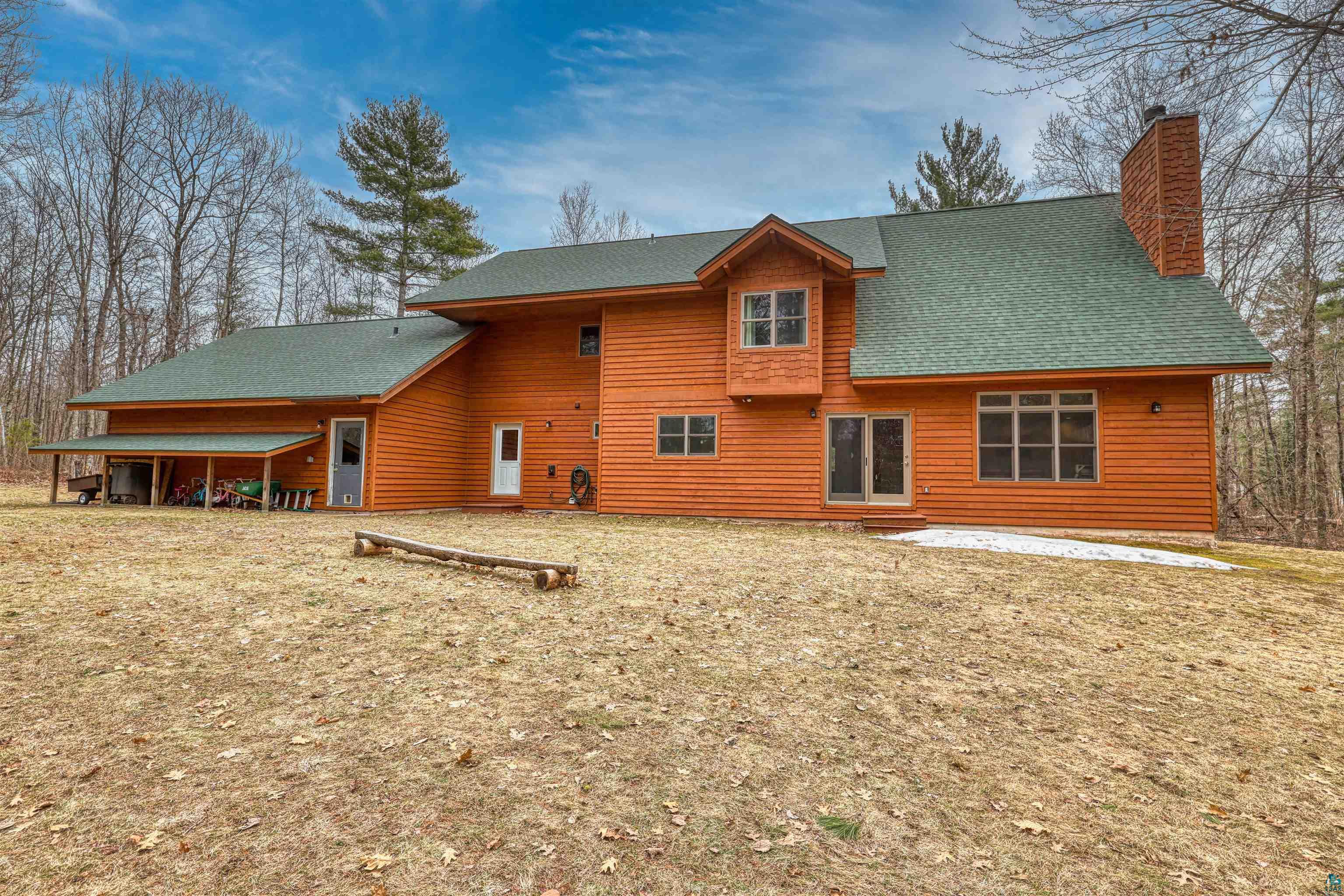 16539 Acorn Ridge Hayward, WI 54843 - Photo 4 of 58 Back of property with a chimney and roof with shingles