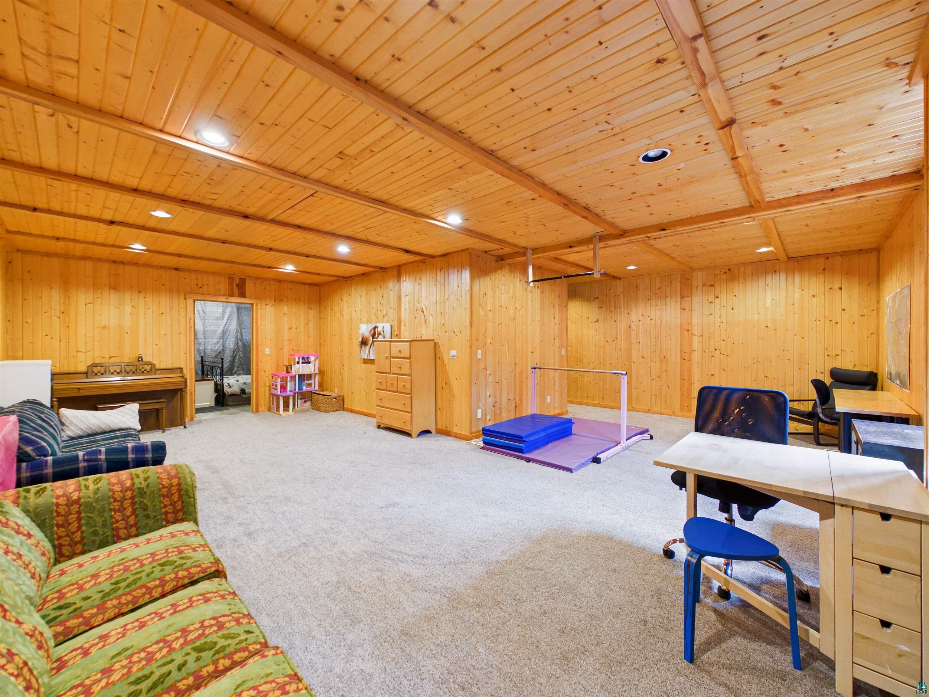 16539 Acorn Ridge Hayward, WI 54843 - Photo 45 of 58 Playroom with recessed lighting, a wooden ceiling with exposed beams, carpet, and wooden walls