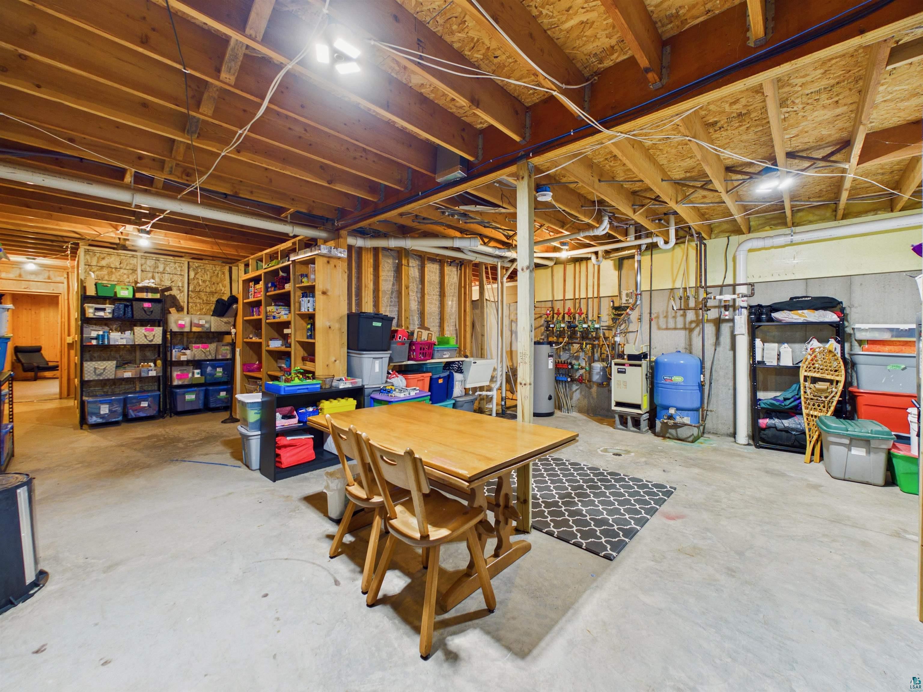 16539 Acorn Ridge Hayward, WI 54843 - Photo 50 of 58 Unfinished basement featuring a water pressure tank and water heater