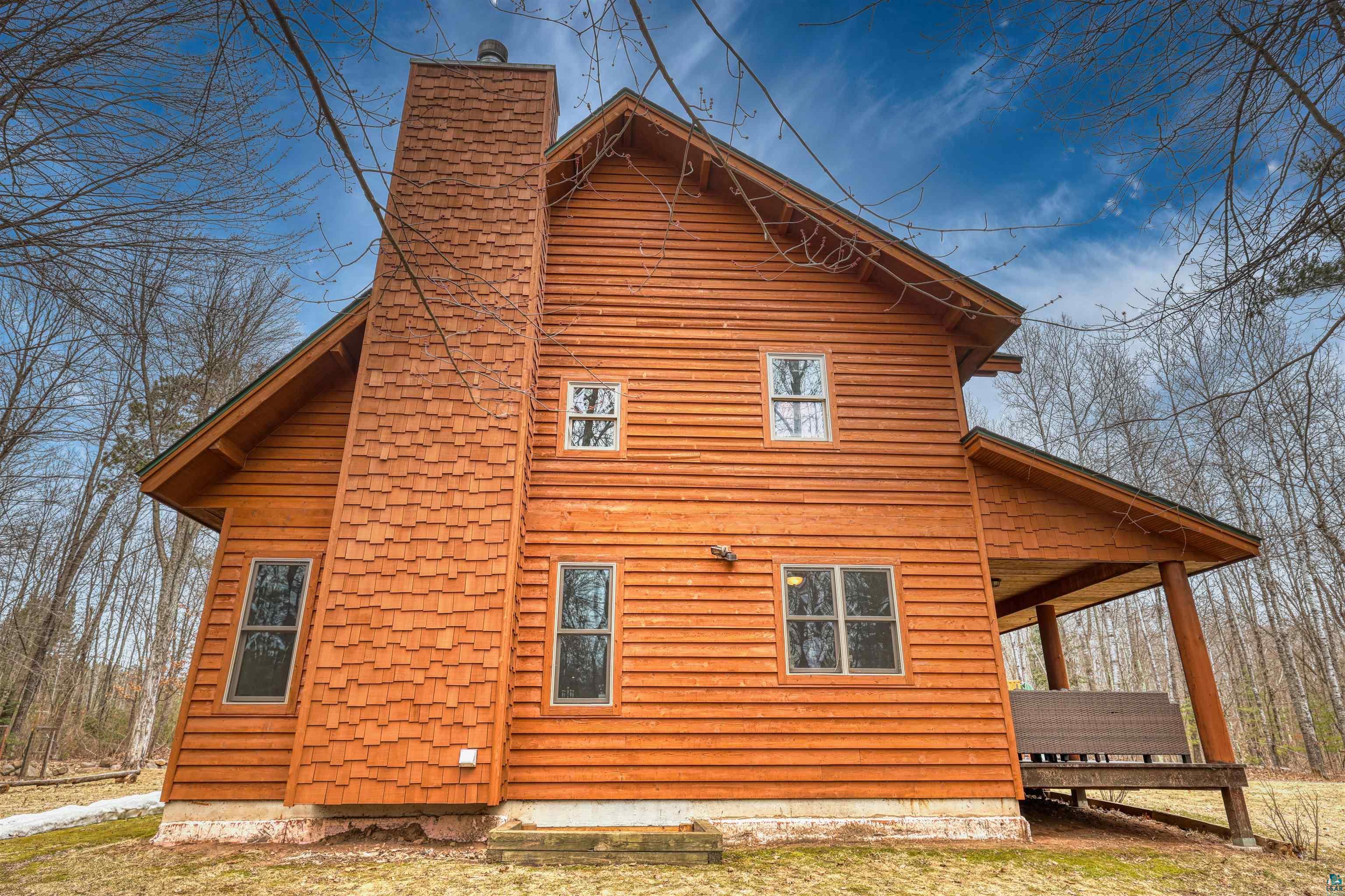 16539 Acorn Ridge Hayward, WI 54843 - Photo 54 of 58 View of side of home featuring a chimney