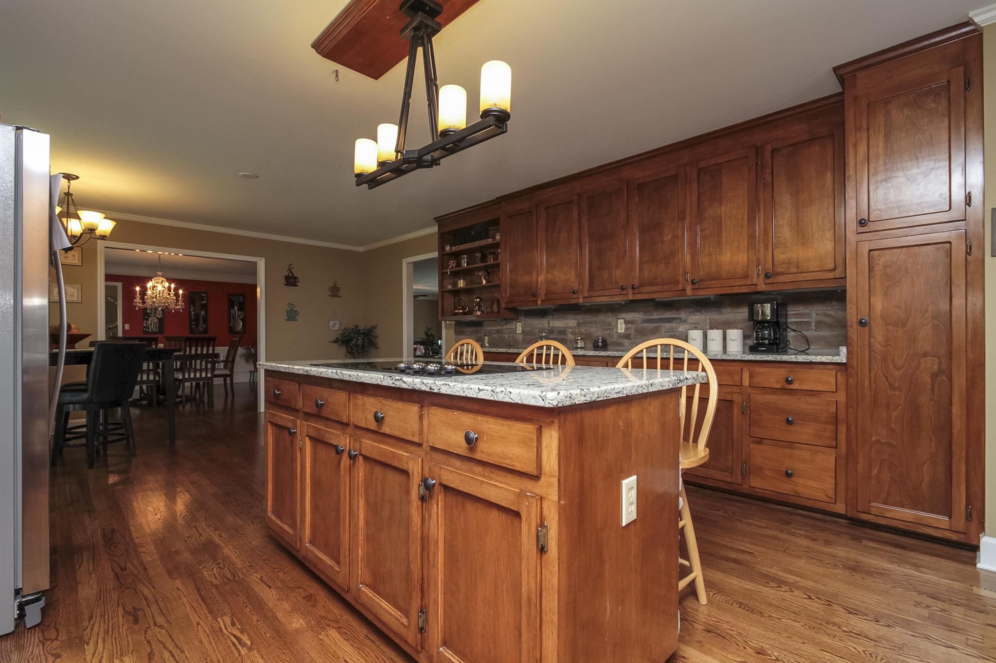 962 Alford Road Murfreesboro, TN 37129 - Photo 12 of 29 a kitchen with stainless steel appliances granite countertop a sink a stove a refrigerator cabinets and wooden floor