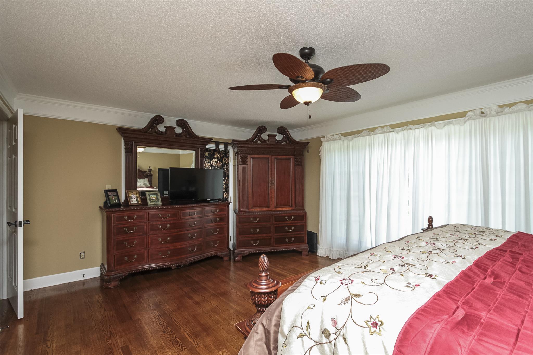 962 Alford Road Murfreesboro, TN 37129 - Photo 15 of 29 a bedroom with a bed and a chandelier