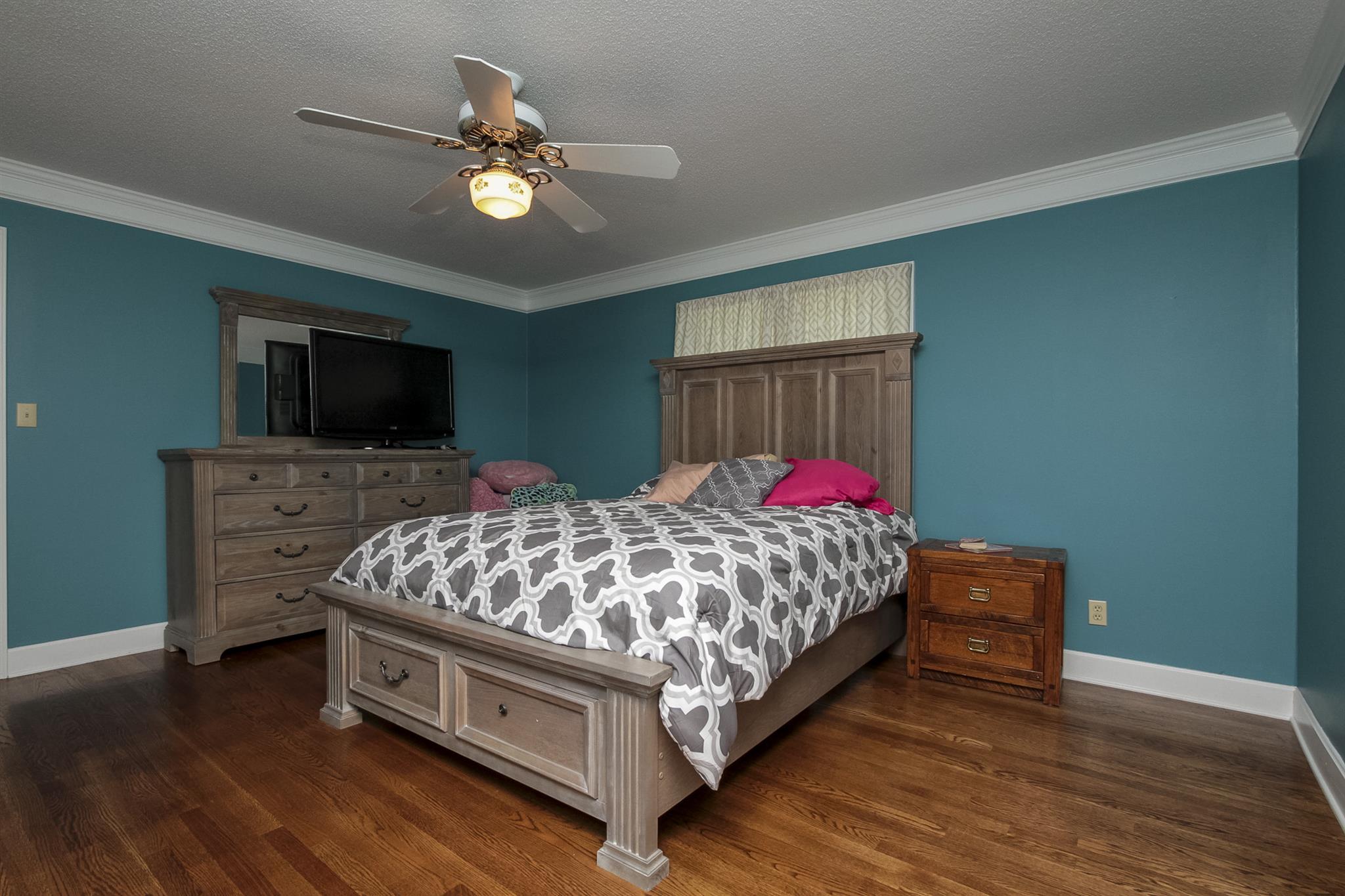 962 Alford Road Murfreesboro, TN 37129 - Photo 19 of 29 a bed sitting in a bedroom and tv on table