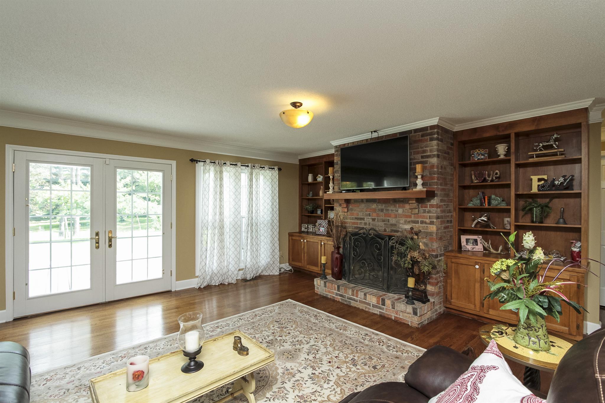 962 Alford Road Murfreesboro, TN 37129 - Photo 8 of 29 a living room with furniture a fireplace and a flat screen tv