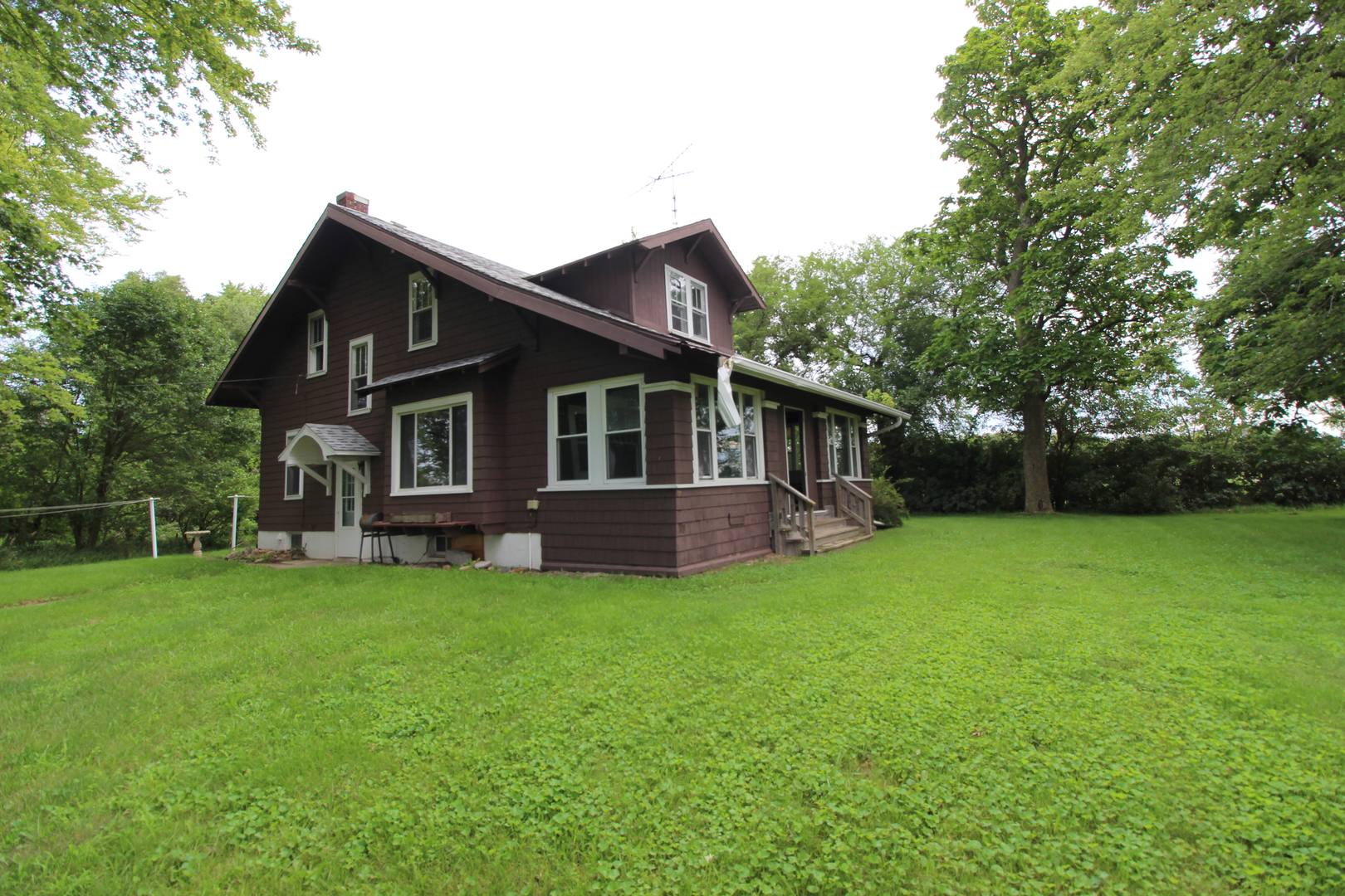 3523 West 2000 S Road Kankakee, IL 60901 - Photo 2 of 20 a front view of a house with a garden and trees