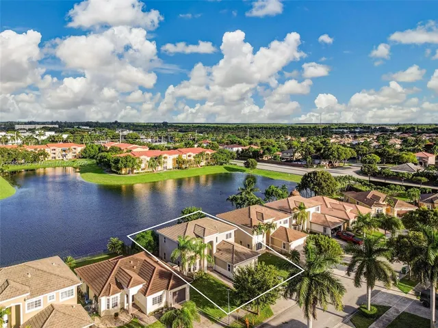 a bathroom with a granite countertop sink a mirror and a bathtub