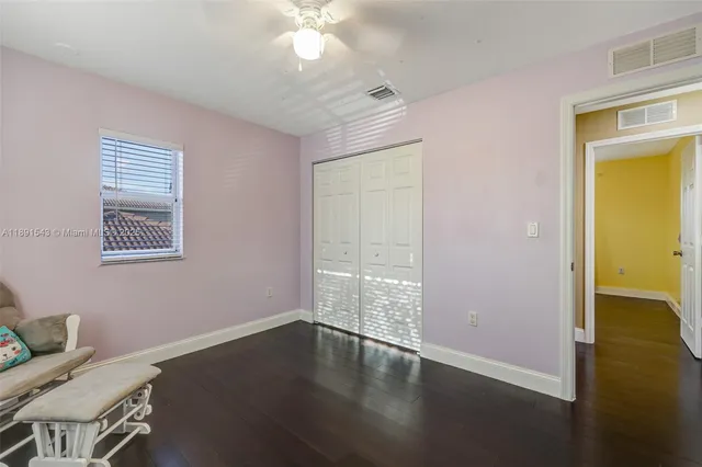 a view of hallway with furniture and a potted plant