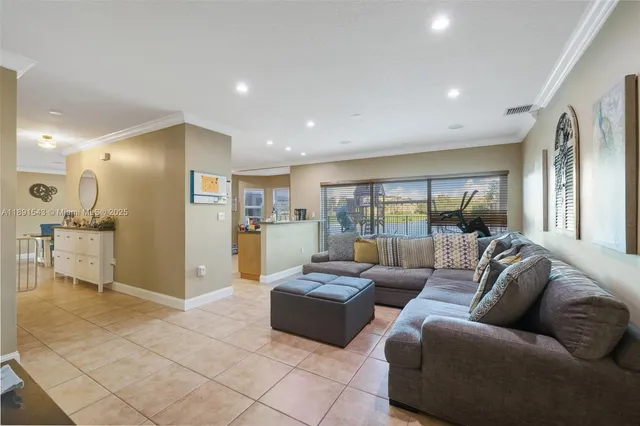 a kitchen that has a lot of furniture a sink and a stove