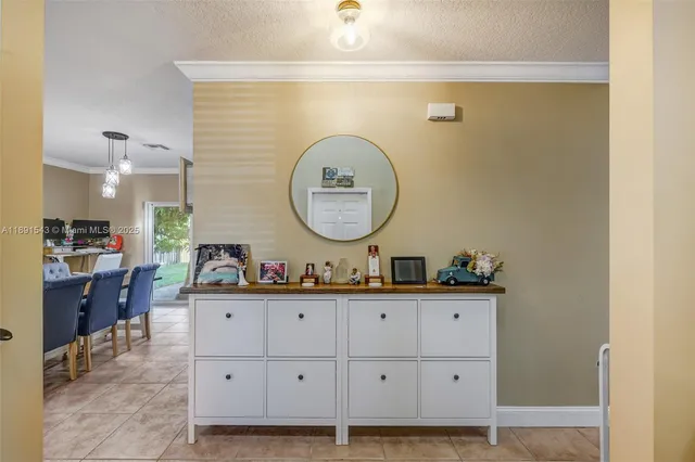 a view of a patio with couches chairs under an umbrella