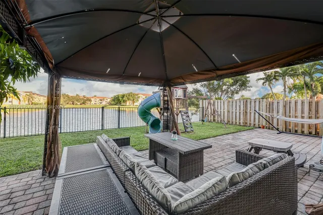 a front view of a house with garden and sitting area