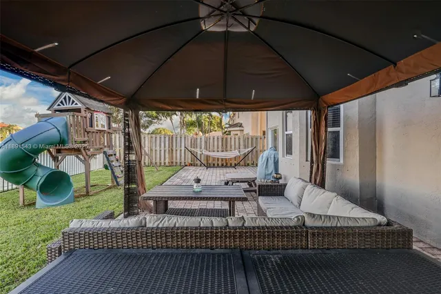 a bathroom with a sink mirror toilet and next to a window