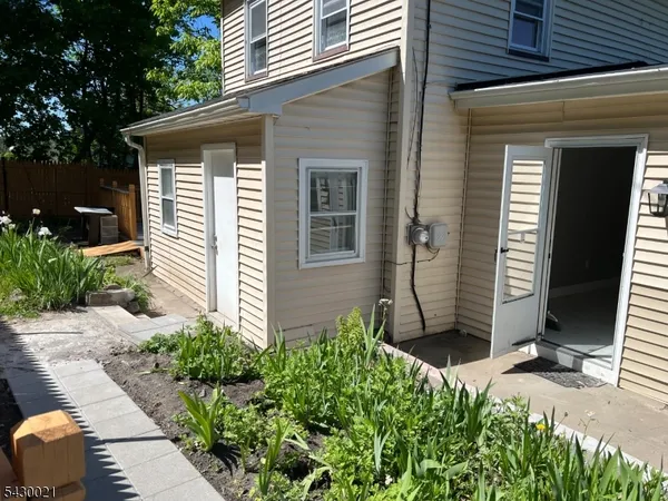 front view of a house with potted plants