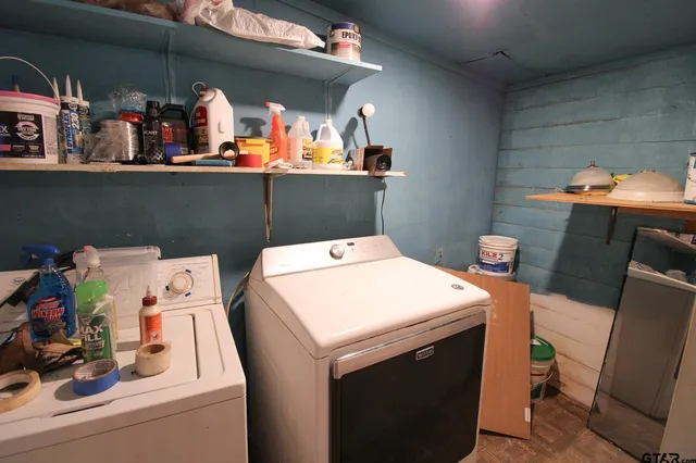 a utility room with dryer washer and shoe rack