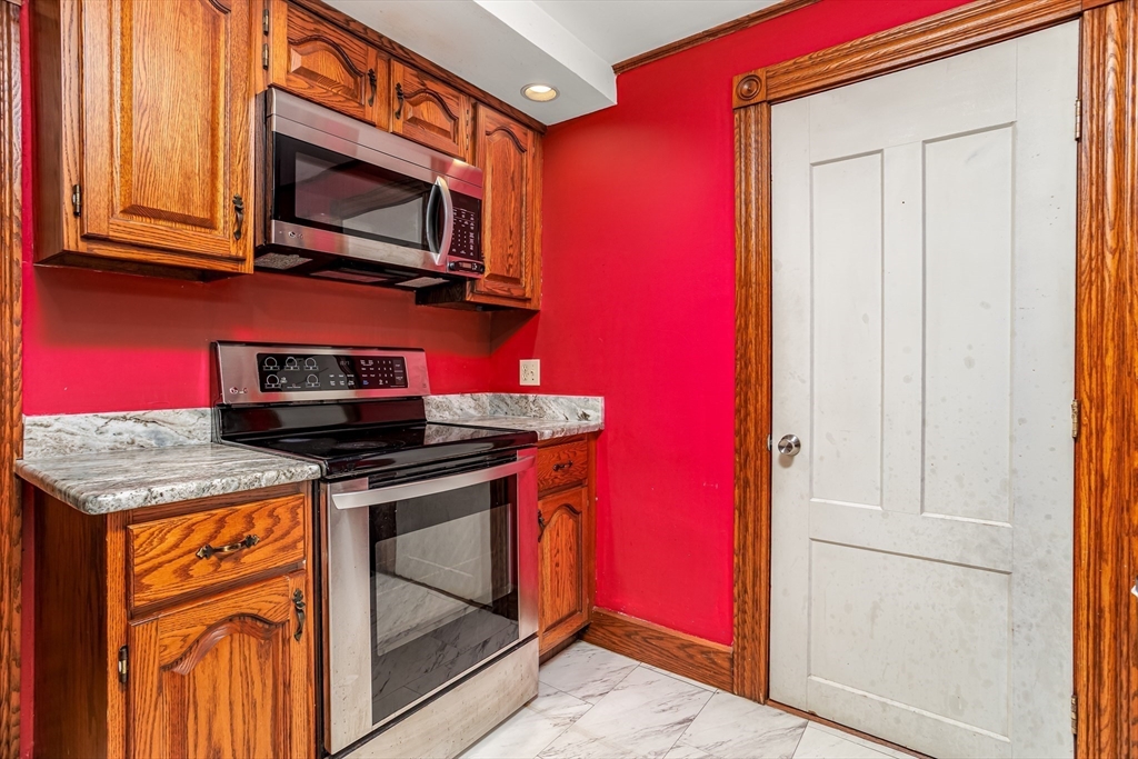 54 Charles Street Gardner, MA 01440 - Photo 8 of 40 a kitchen with stainless steel appliances granite countertop a stove microwave and cabinets