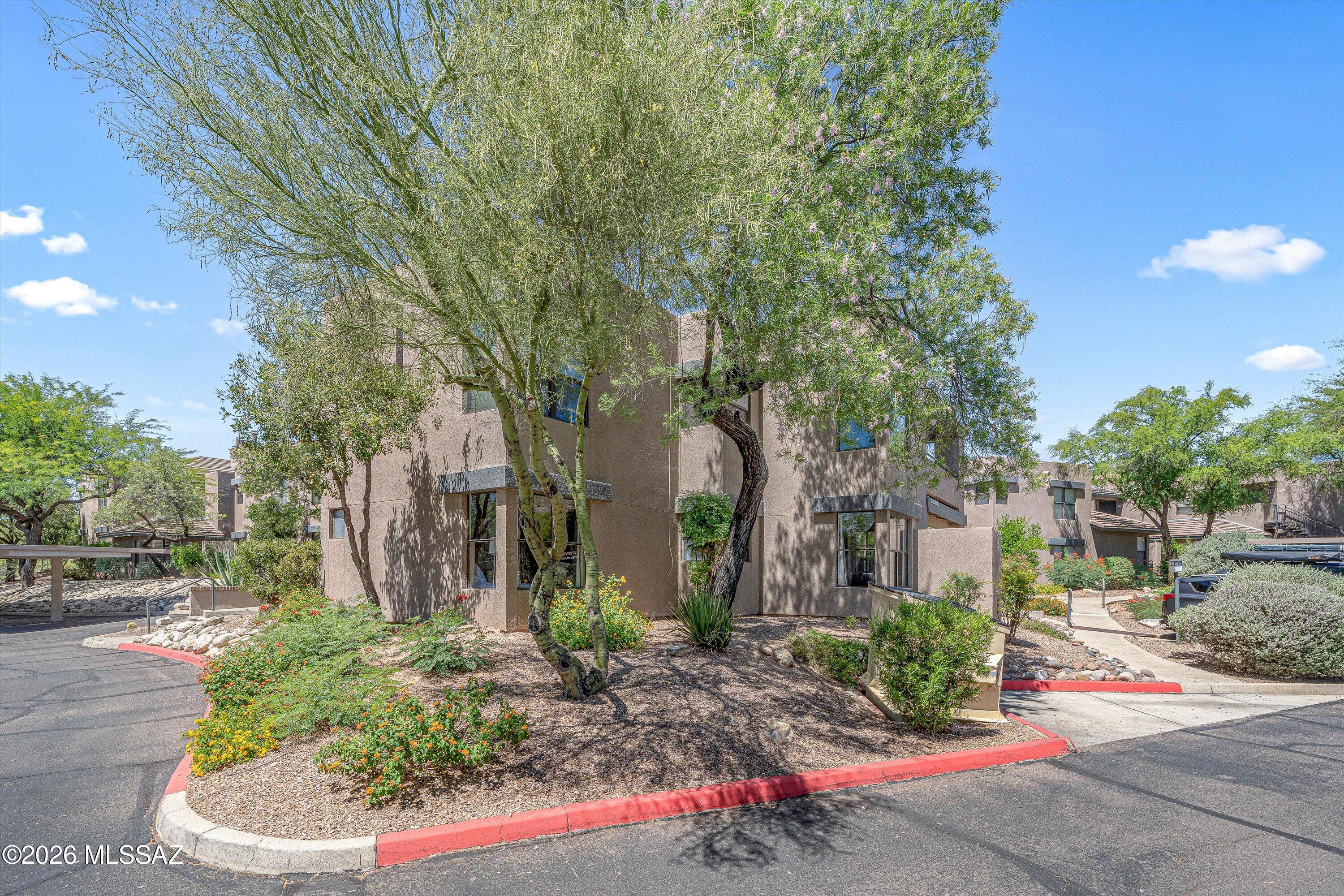 5855 North Kolb Road, Unit 8106 Tucson, AZ 85750 - Photo 24 of 34 a front view of a house with a yard