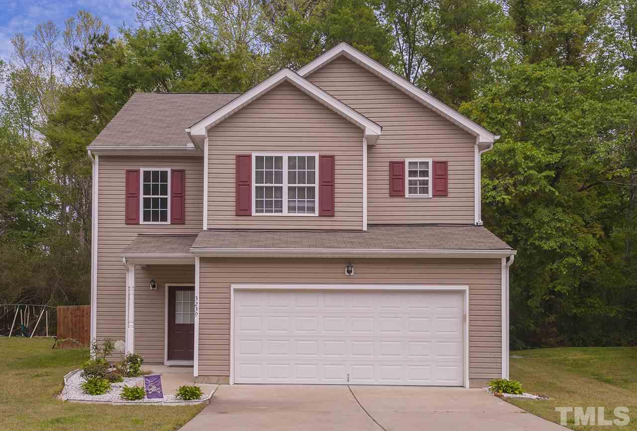 3239 Polite Lane Raleigh, NC 27610 - Photo 1 of 17 a front view of a house with a yard and garage